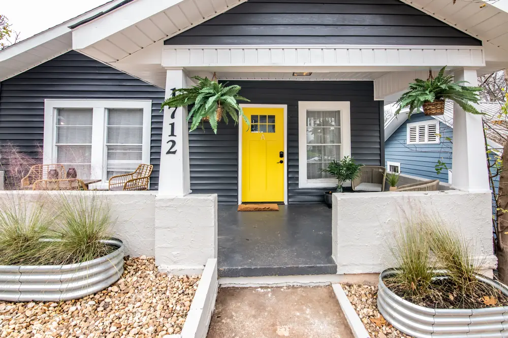 The yellow front door to Unit A