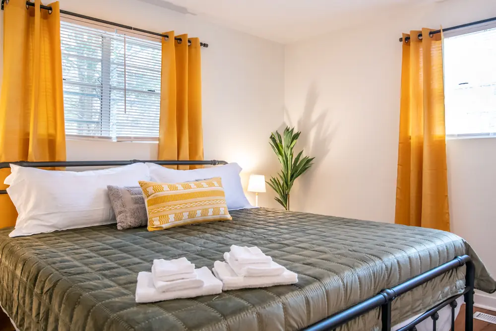 Unit B bedroom with mustard curtains