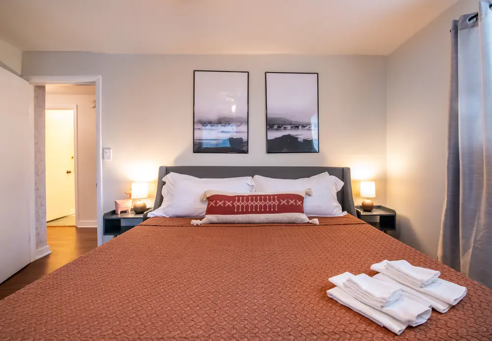 Unit B bedroom with a rust bedspread