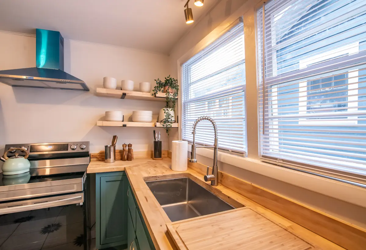 Unit B kitchen with teal cabinets