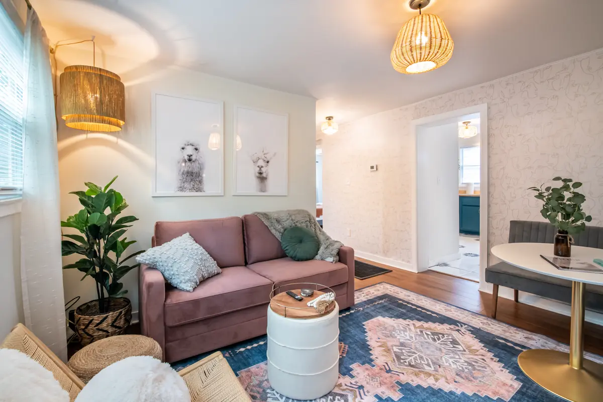 Unit B living room with a pink sofa